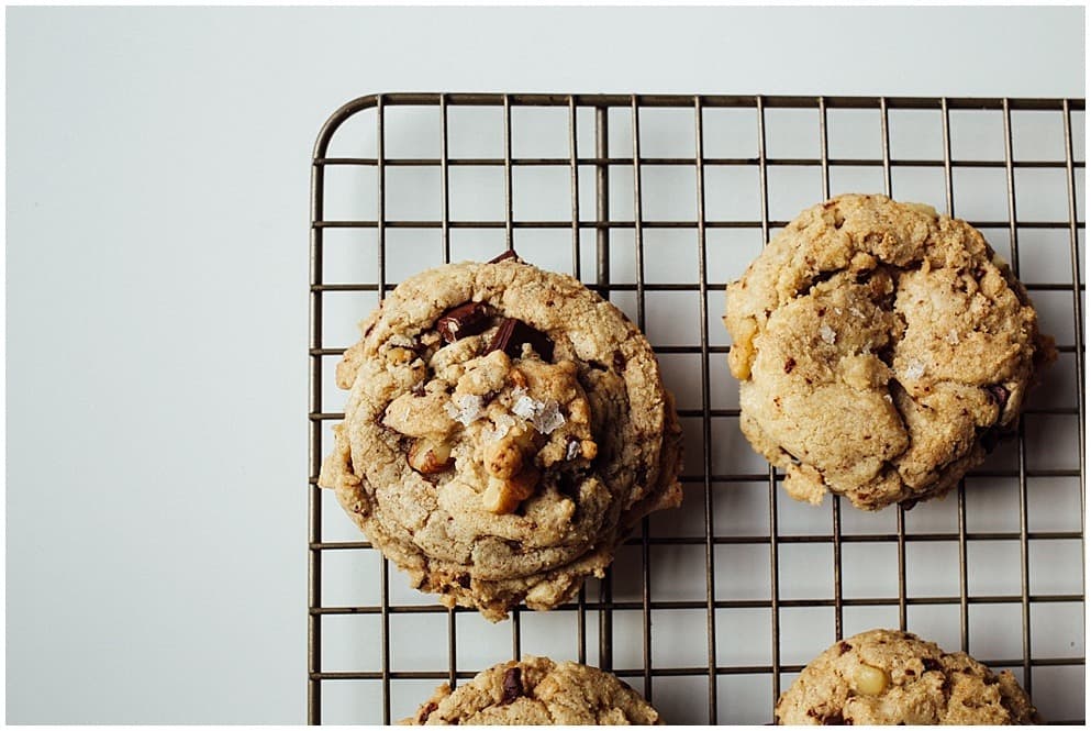 Candied Walnut Chocolate Chip Cookies Recipe by The Wood and Spoon Blog by Kate Wood. These are chewy chocolate chip cookies warmly scented with coriander and other spices and candied walnuts. You can substitute pecans or other nuts here. These make terrific holiday or Christmas chocolate chip cookies and can be made ahead and frozen. Save the extra candied walnut pieces for future baked goods. Find the recipe on thewoodandspoon.com. cookies, cookie recipes, walnuts, candied walnuts, cookies with nuts.