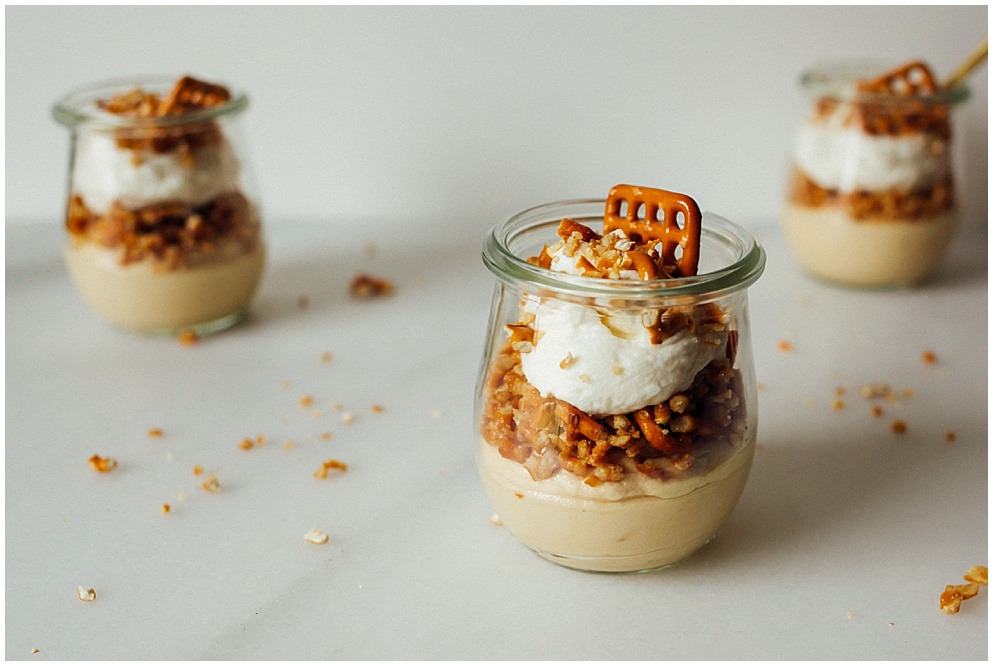 Cookie Butter Pretzel Mousse by the wood and spoon blog by kate wood. This is a simple, no bake recipe featuring a cookie butter (biscoff / speculoos) mousse made with cream cheese and whipped cream. The mousse is prepared in individual jars (Weck, but you can use Mason jars) and topped with a salty pretzel crumble/ crumb made with butter and brown sugar and salt. It's all topped with more sweetened whipped cream and pretzels. This recipe is fast and takes less than 30 minutes to make. Store in the fridge to make ahead. Recipe on thewoodandspoon.com