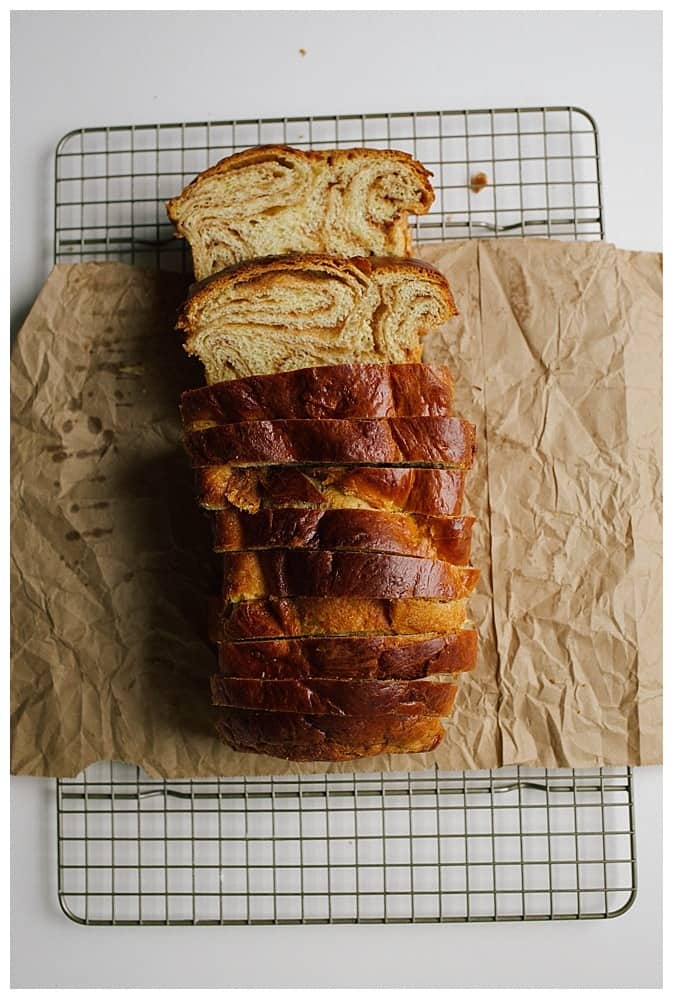 Cinnamon Swirl Bread Recipe by the Wood and Spoon blog by Kate Wood. This recipe makes two loaves of cinnamon babka or brioche style bread using butter and eggs. The bread is soft and sweet like Hawaiian bread but makes homemade bread similar to commercial breakfast bread. There is a tutorial on how to roll these fluffy loaves and how to get lots of swirls throughout. Find the recipe on thewoodandspoon.com