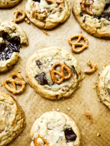 Bourbon Toffee Chocolate Chunk Cookies by Wood and Spoon blog. These are chewy chocolate chip cookies filled with bourbon, toffee, and pretzels. These cookies are sweet and salty with a hint of whiskey, making them the perfect dessert to serve at Kentucky Derby parties. Bourbon lovers will love these cookies! Find the recipe and how-to at thewoodandspoon.com