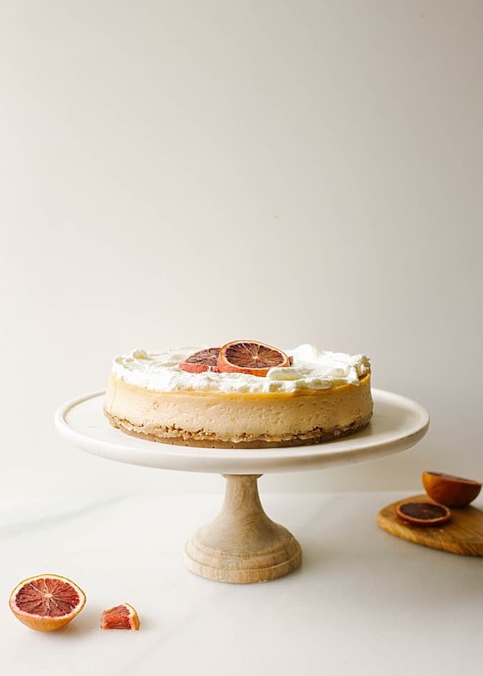 Blood Orange Cheesecake Recipe by The Wood and Spoon blog by Kate Wood. This recipe is for a citrus cheesecake flavored with ruby red blood oranges, The crust is a cinnamon brown sugar and graham cracker crust and the whole thing is topped with a sweet whipped cream topping. The cheesecake, made with cream cheese, is adapted from miette bakery, and has a beautiful pink orange hue due to the oranges! This recipe gives a lot of how-to's on making cheesecakes without crack, bubbles, soggy crust from leaking water bath, etc so check it out on thewoodandspoon.com