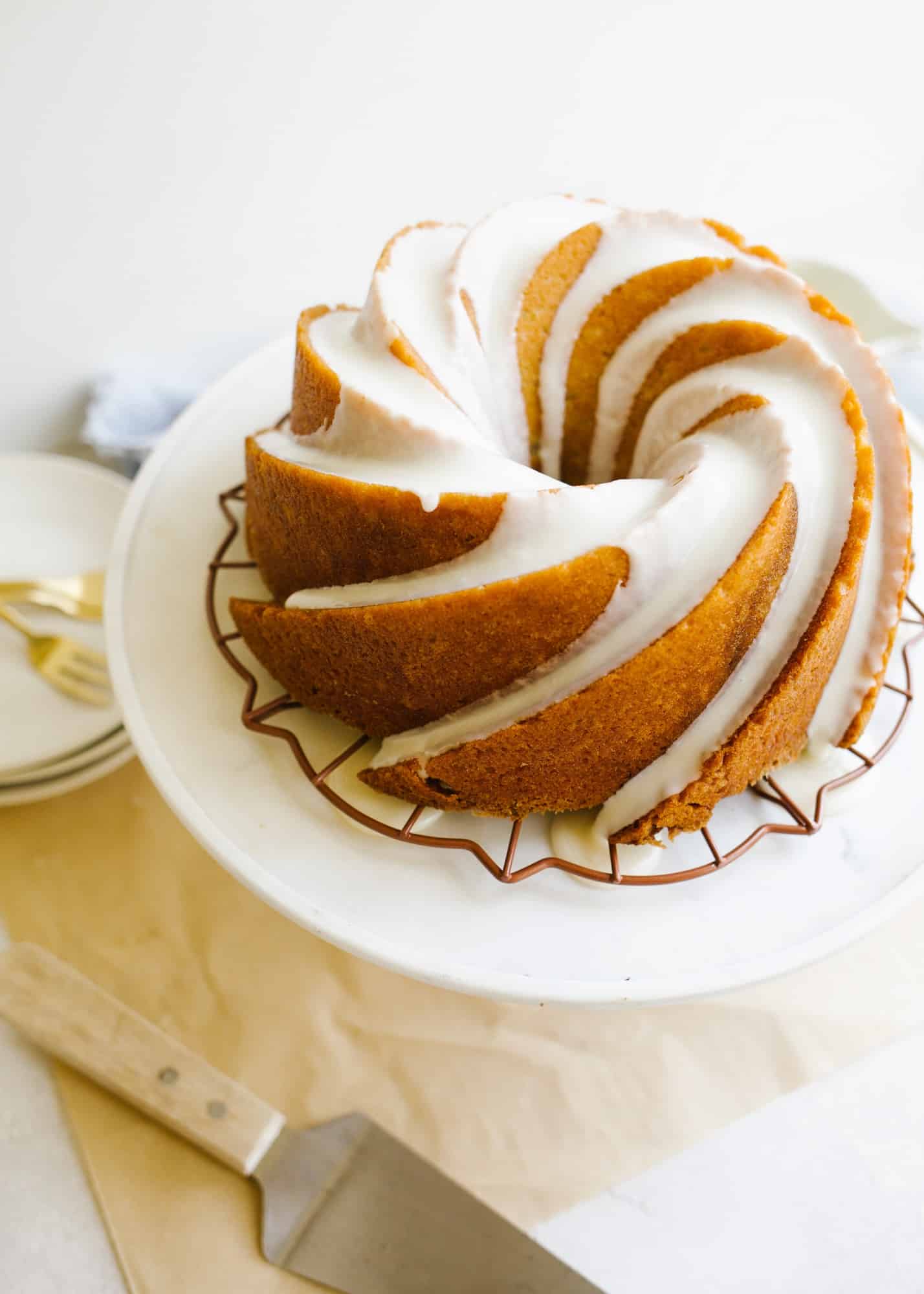 Bourbon Bundt Cake by Kate Wood. This is a boozy and moist bundt cake make with Kentucky whiskey and a bourbon glaze. The cake is fluffy and tall and serves as a great breakfast or brunch or dessert item! It comes together in one bowl and can be made in advance. Learn more about this fall simple cake on thewoodandspoon.com