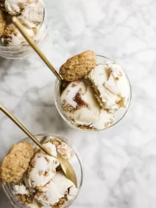 Oatmeal Cookie Chunk Ice Cream Recipe by The Wood and Spoon Blog by Kate Wood. This is a ice cream machine maker recipe inspired by Ben and Jerry's famous oatmeal cookie ice cream. oatmeal infuses the cream and milk mixture and a cinnamon swirl filling and chunks of chewy oatmeal cookies are added to this to make it the best oatmeal cookie filled ice cream ever. Find the simple and fun summer frozen dessert recipe on thewoodandspoon.com