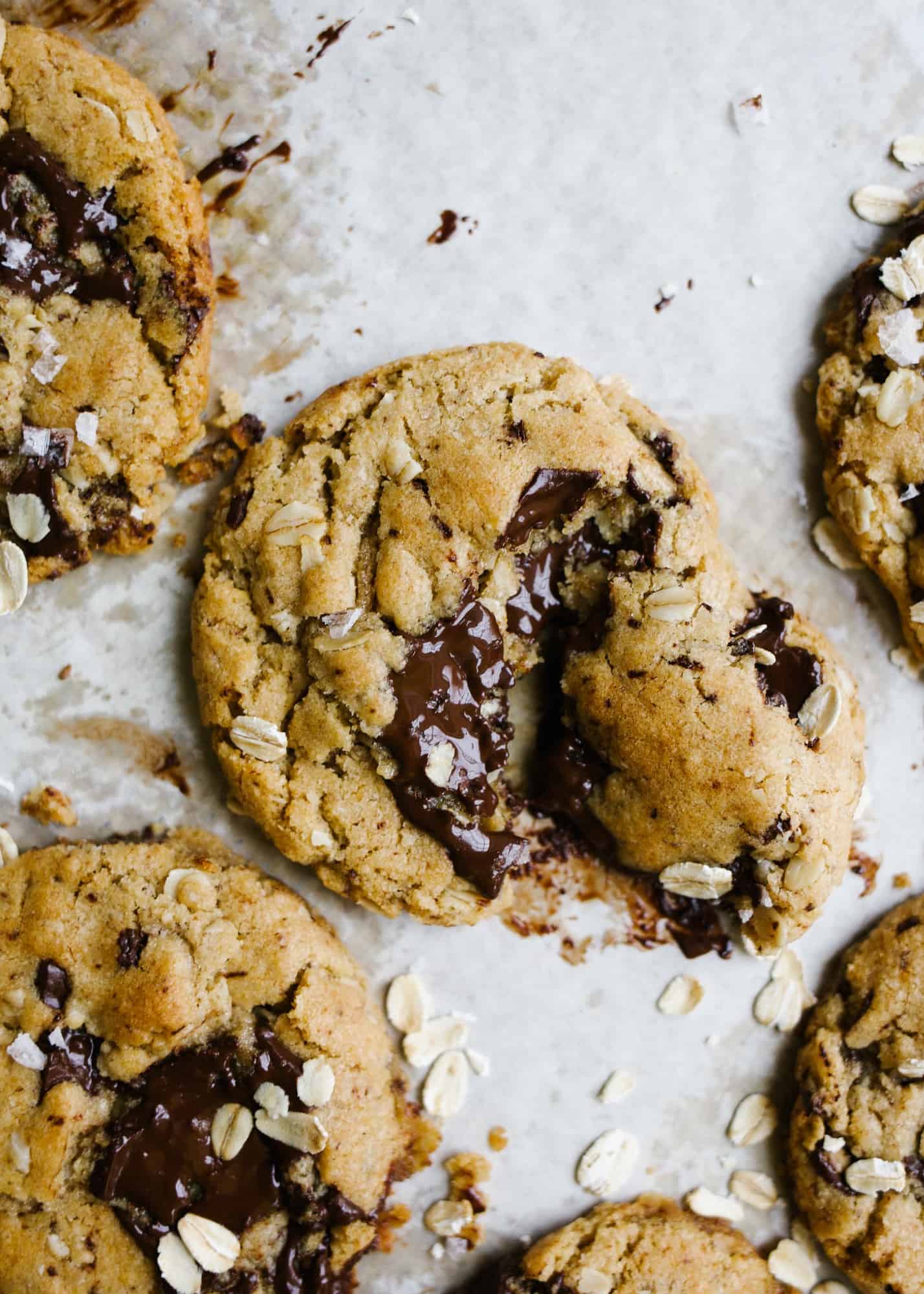 Vegan Peanut Butter Oatmeal Chocolate Chunk Cookies by Wood and Spoon blog. These are simple flax seed egg and coconut oil cookies made with vegan ingredients, creamy peanut butter, oats, and chocolate. The cookies have crisp edges and soft insides and tons of flavor. These healthy cookies taste delicious and are beautiful too! Learn how simple it is to make vegan cookies here on thewoodandspoon.com