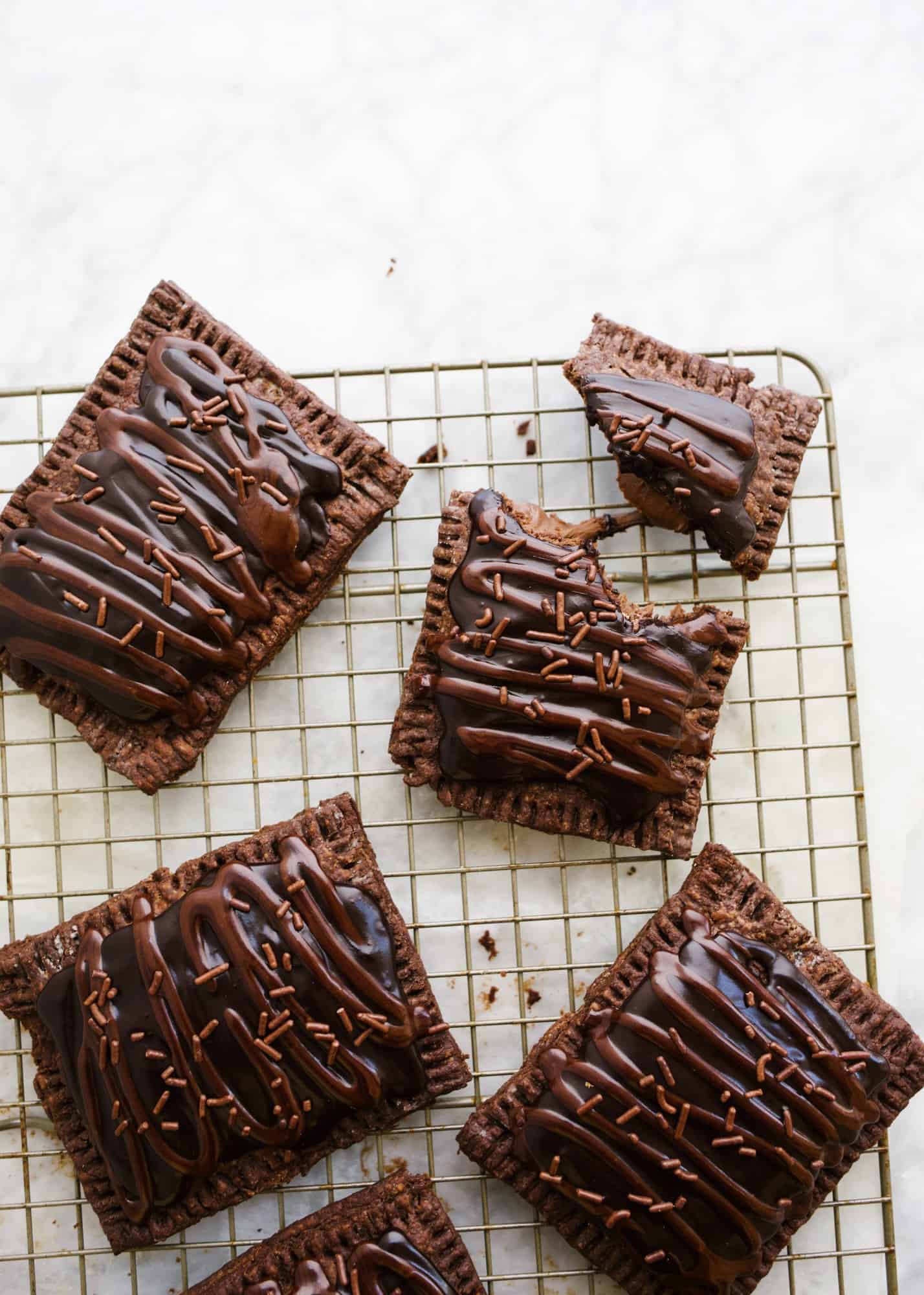 Double Chocolate Pop-Tarts by Wood and Spoon. These are cocoa powder pie dough pieces stuffed with more chocolate, crimped, baked, a drizzled with a cocoa icing. For faster pop-tarts, you can stuff these with any of your other favorite fillings too: marshmallow fluff, peanut butter, Nutella, or even jam! Learn how simple homemade chocolate pop-tarts are here on thewoodandspoon.com