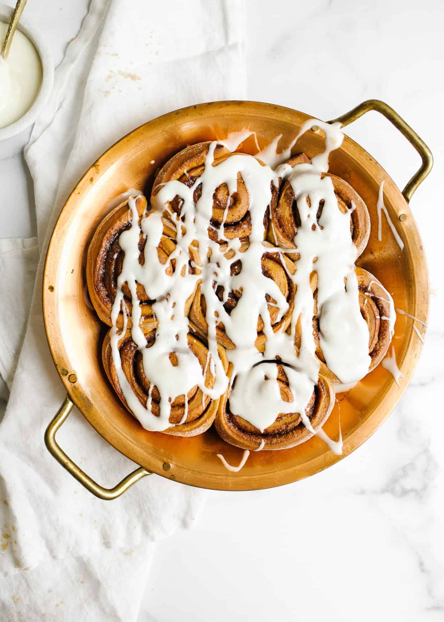 Gingerbread Cinnamon Rolls by Wood and Spoon. This recipe is for holiday spiced morning buns filled with cinnamon, ginger, nutmeg, and other Christmas cookie spices. The recipe can be prepped overnight and made in advance and the whole thing has a tangy lemon cream cheese icing that can be frosted on the fluffy giant rolls. Learn how to roll the cookies and find out more about this recipe on thewoodandspoon.com by Kate Wood.