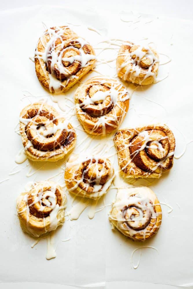 Hazelnut Cinnamon Rolls Recipe by The Wood and Spoon Blog by Kate Wood. A simple yeast dough inspired by The Pioneer Woman Cinnamon Rolls filled with a hazelnut brown sugar and cinnamon crunchy filling. The whole thing is topped with a cream cheese frosting. You can make giant cinnamon rolls or make it into a find cinnamon roll cake in a springform pan. Find the recipe for these fabulous fancy brunch or breakfast menu item at thewoodandspoon.com