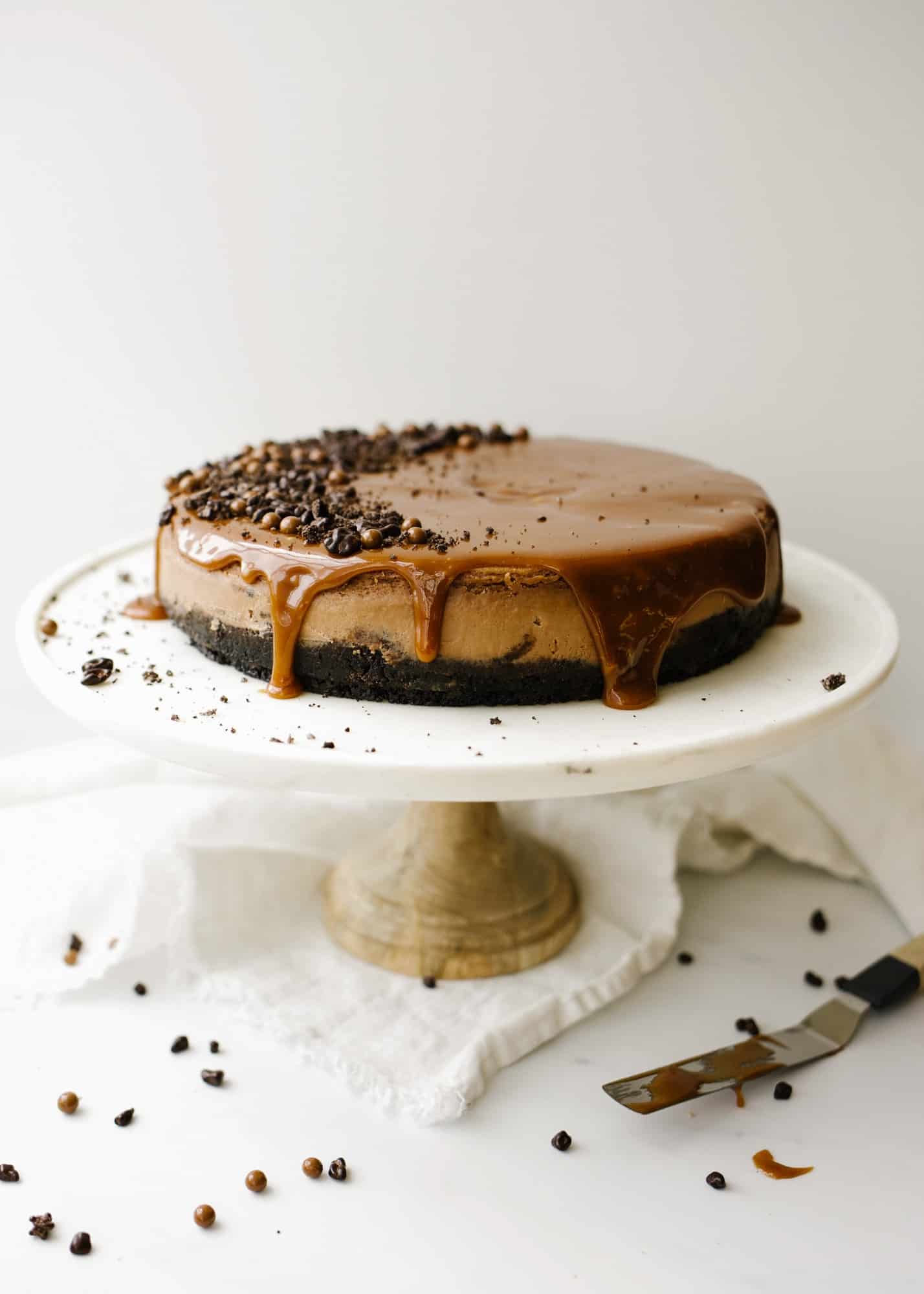 Chocolate Mascarpone Cheesecake by Wood and Spoon blog. This is a creamy chocolate cheesecake made with mascarpone cheese, a chocolate sandwich cookie Oreo crust, and a rich caramel topping. The crust is scented with espresso powder and lends a buttery crunch to the otherwise smooth dessert. This is a decadent treat for chocolate lovers and a great alternative to a cream cheese cheesecake. Learn how to make it on thewoodandspoon.com