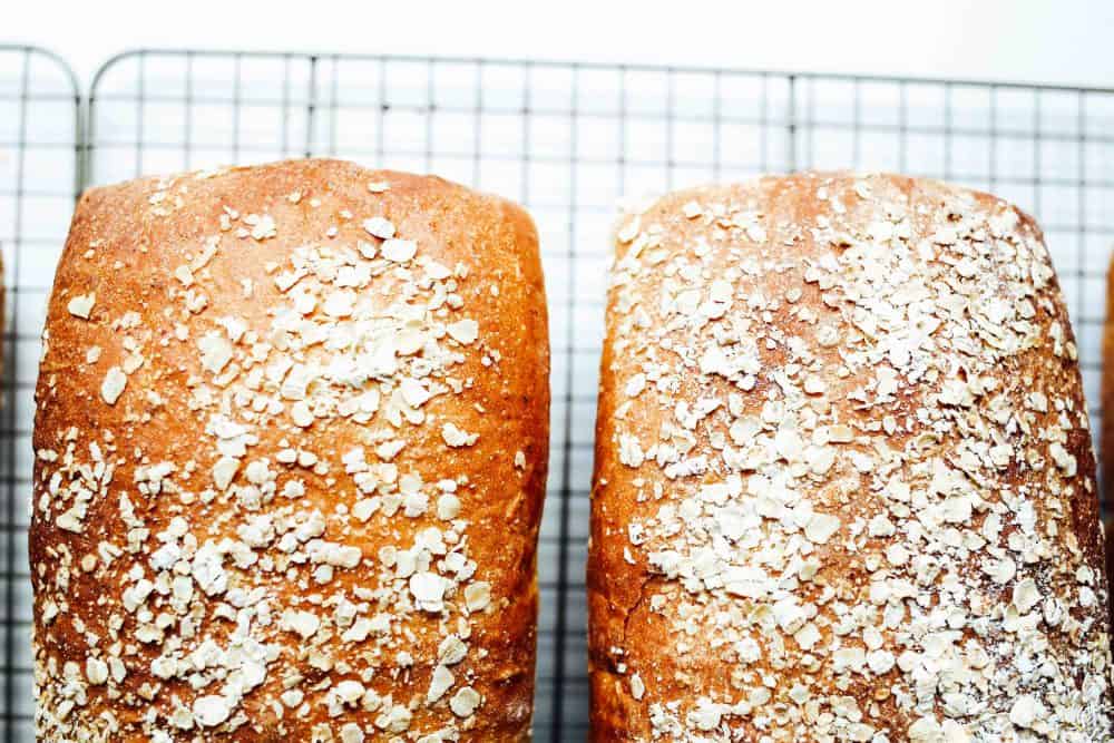 Honey Oat Bread Recipe by The Wood and Spoon Blog by Kate Wood. This is a simple, delicious, and healthy homemade sandwich bread that is sweetened with honey and has old fashioned or quick oats in there. It's a soft, white, chewy bread that makes two loaves. Find the recipe for this simple yeast bread on thewoodandspoon.com