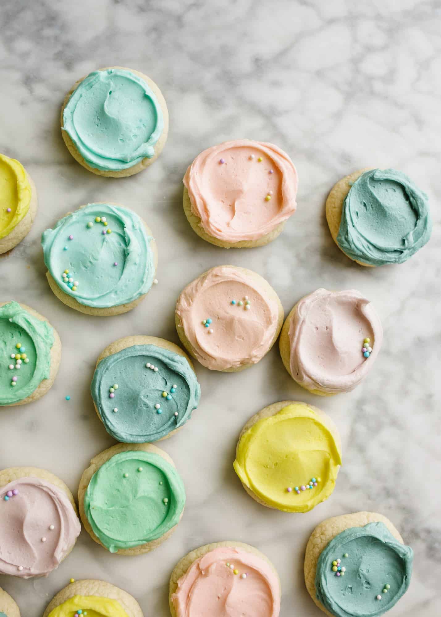 Pastel Lofthouse Cookies by Wood and Spoon Blog. These are copycat cookies for mini Lofthouse cookies that you can make homemade in your own favorite buttercream colors! Learn how simple these drop sugar cookies are and how to make that soft and fluffy buttercream cookie frosting on thewoodandspoon.com