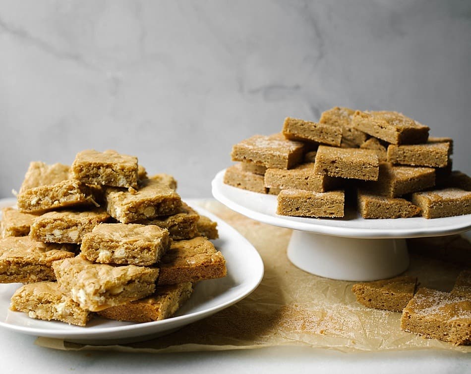 Brown Butter Blondies by The Wood and Spoon Blog by Kate Wood. This is a recipe for how to make brown butter blondies with a few different variations. First, a fluffy blondie filled with white chocolate chunks / chips and shredded sweetened coconut. Second, a snickerdoodle type blondie filled with cinnamon and sugar- rich, buttery, and delicious. These blondies can be whipped up in one bowl and serve a crowd. Perfect for tailgating, parties, or to make with kids. You can substitute your favorite toppings- nuts, chocolate chips, or toffee! Find the recipe and the how to on thewoodandspoon.com