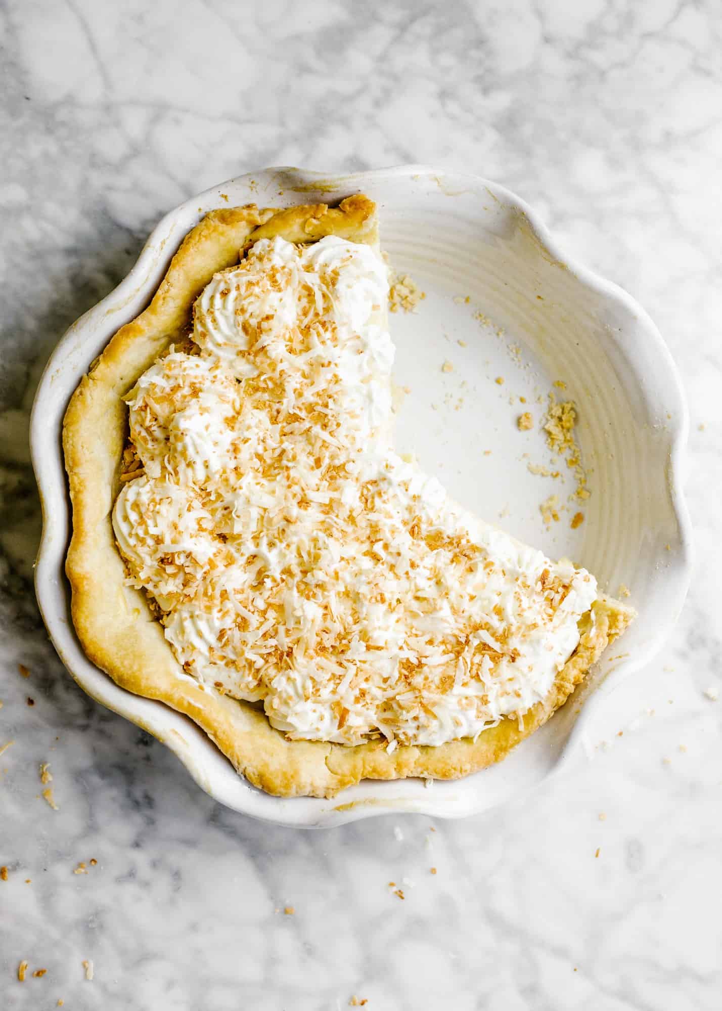 Southern Coconut Cream Pie and our Trip to the Exumas. This is a stovetop vanilla custard pie flavored with sweetened coconut flakes and topped with a homemade whipped cream. The butter and shortening flaky pie crust is filled with the coconut milk filling and it makes for a delicious summertime or spring tropical flavored bake ahead pie for dessert. Learn how simple it is to make southern pies on thewoodandspoon.com