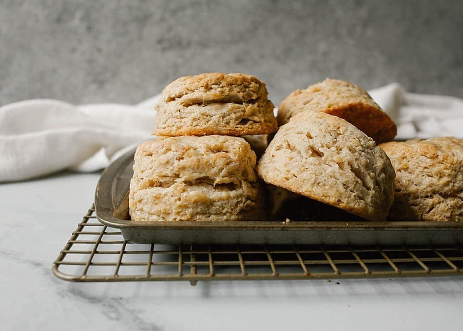 Maple Oatmeal Biscuits Recipe by The Wood and Spoon blog by Kate Wood. This is a simple, one bowl recipe for southern style fluffy layered biscuits filled with rolled oats and pure maple syrup. The biscuits are tall and thick, soft from the addition of buttermilk. Naturally sweet with maple syrup, these are best served for breakfast or as an easy addition to brunch. Find the recipe and the how to on thewoodandspoon.com