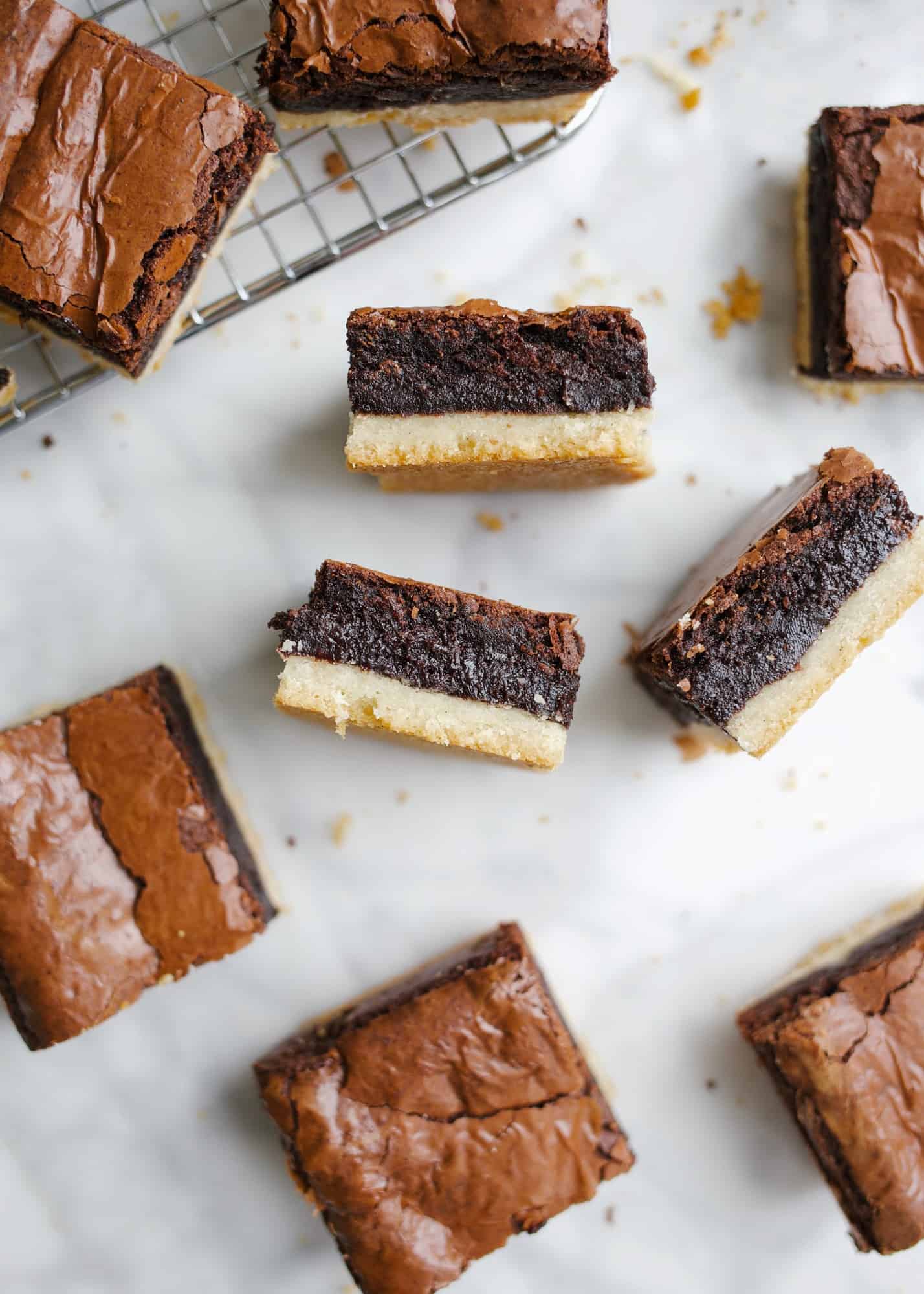 Brownie Shortbread Bars by Wood and Spoon. These are two layer bars made of a buttery vanilla bean shortbread crust and a gooey crackly top brownie. The brownie is rich and fudge without being overly dark, and the crust is crisp and tender. These bars are perfect for the shortbread lovers or for brownie lovers who love a great deal of texture! Learn how simple they are to make on thewoodandspoon.com