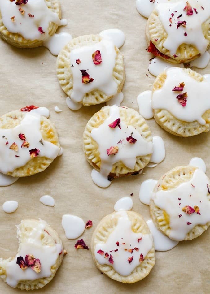 Raspberry Champagne Pop-Tart by Wood and Spoon Blog. These are simple homemade hand pies made with a raspberry champagne jam and a simple champagne glaze icing. Homemade pie dough makes little crimped round tarts that are filled with the simple cornstarch thickened jam. When cool, the desserts are topped with a frosting to sweeten the treats. Find the recipe and how to on thewoodandspoon.com by Kate Wood.