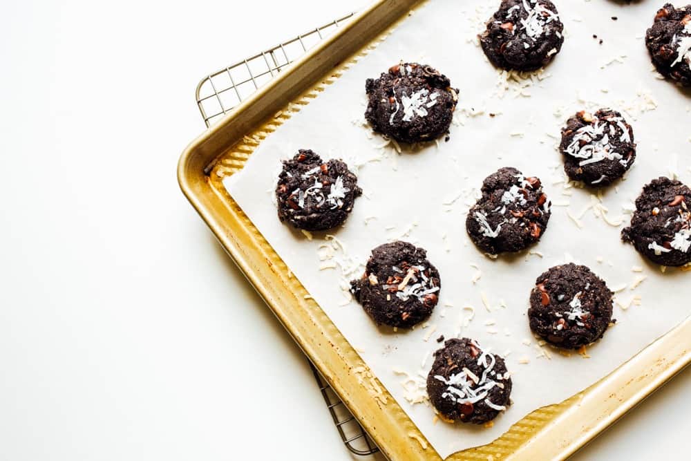 Coconut Almond Chocolate Cookies Recipe by The Wood and Spoon Blog by Kate Wood. This is a simple, almost paleo recipe that includes shredded coconut, whole almonds and almond butter, vegan chocolate chips or chunks. This is a great healthy almost clean baking cookie for special diets that you can make. Recipe at thewoodandspoon.com