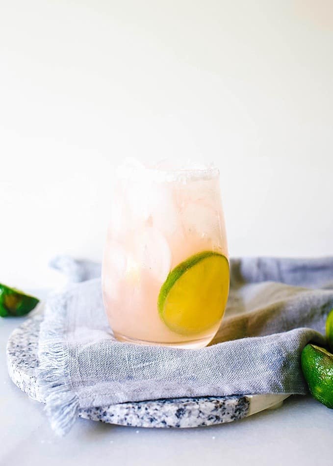 Rosé Margaritas By Wood and Spoon blog. These rose margaritas contain just a few ingredients- tequila, simple syrup, fresh lime juice, and rose wine. Simple to make and easy to batch for a large crowd, these refreshing summer beverages are the perfect way to celebrate cinco de mayo or other poolside fiesta. Find the recipe on thewoodandspoon.com!