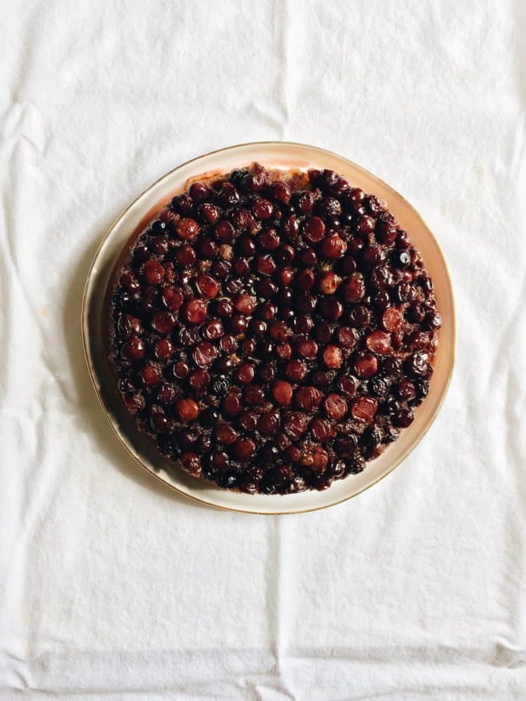 concord grape upside down cake recipe by the wood and spoon blog by kate wood. This is a buttery golden single layer cake made with juicy seedless concord grapes. The cake gets baked in the oven and gooey pieces of fruit keep the cake moist for days. This is a great cake to eat for breakfast or dessert or tea time. Make this cake in a springform pan. Find the recipe and how to roast grapes on thewoodandspoon.com