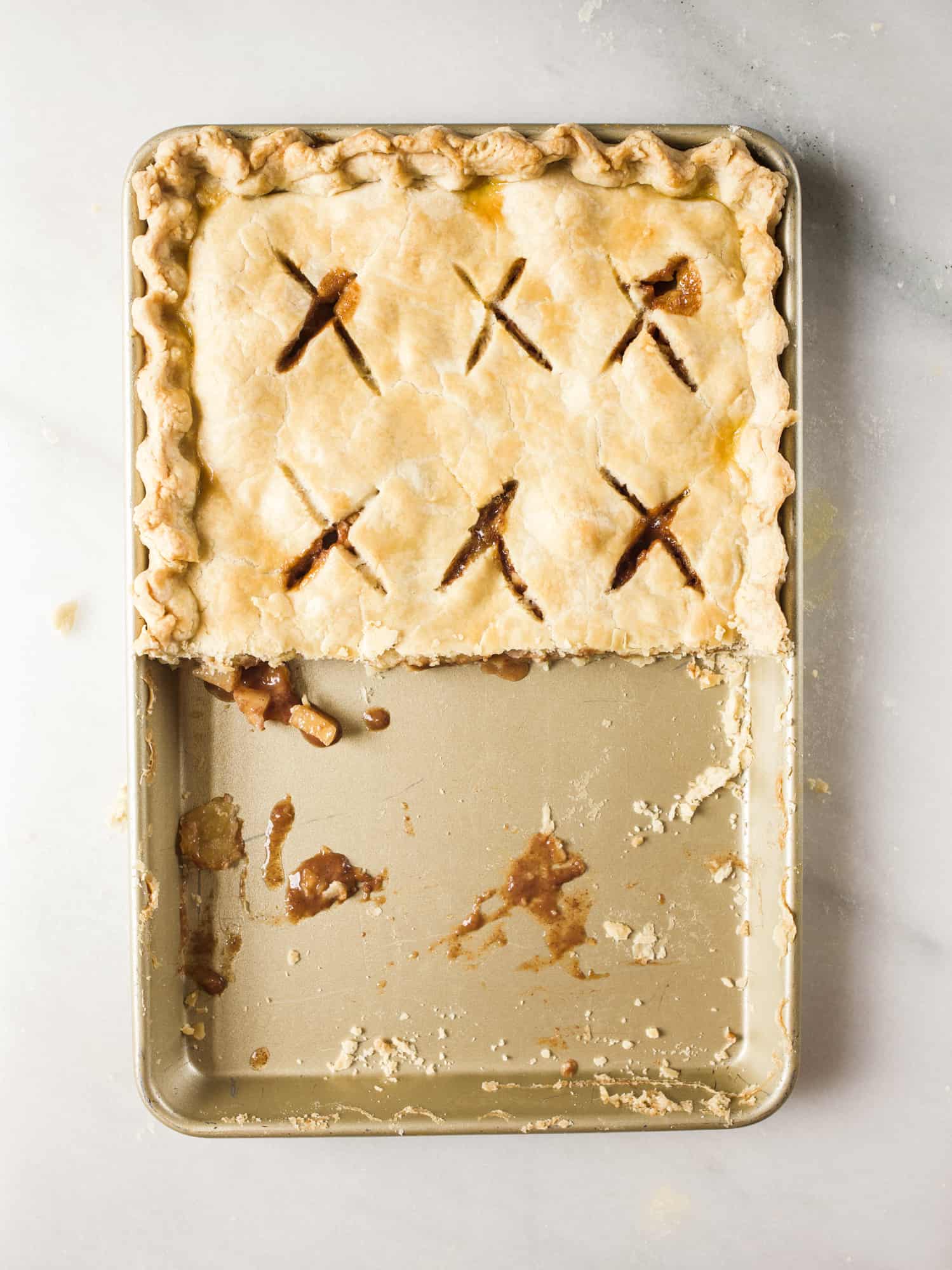 Caramel Apple Slab Pie Recipe by The Wood and Spoon Blog by Kate Wood. This is a pie recipe prepared in a jelly roll pan, quarter sheet pan, or a 9"x 13" pan. Filled with tart autumn apples and a salted caramel sauce inspired by bobby flay, fall dessert is perfect for serving a crowd and can easily be made ahead. Find the details and how to make your own Thanksgiving inspired treat on thewoodandspoon.com