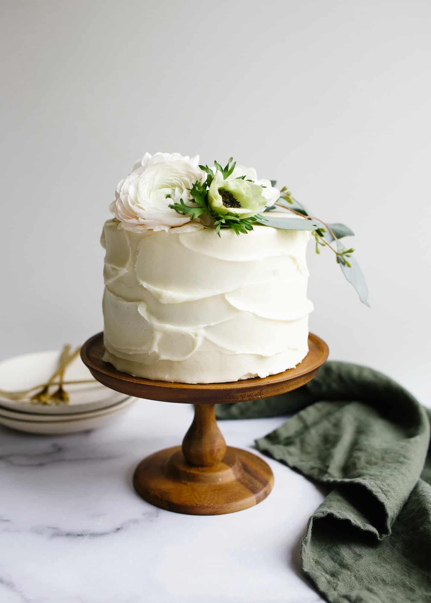 Red Velvet Cake by Wood and Spoon blog. This is a cocoa flavored layer cake with a tangy cream cheese frosting. This recipe is fluffy and festive with bright red layers and is perfect for holiday baking or birthday celebrations. Learn more about how to make this dessert on thewoodandspoon.com by Kate Wood