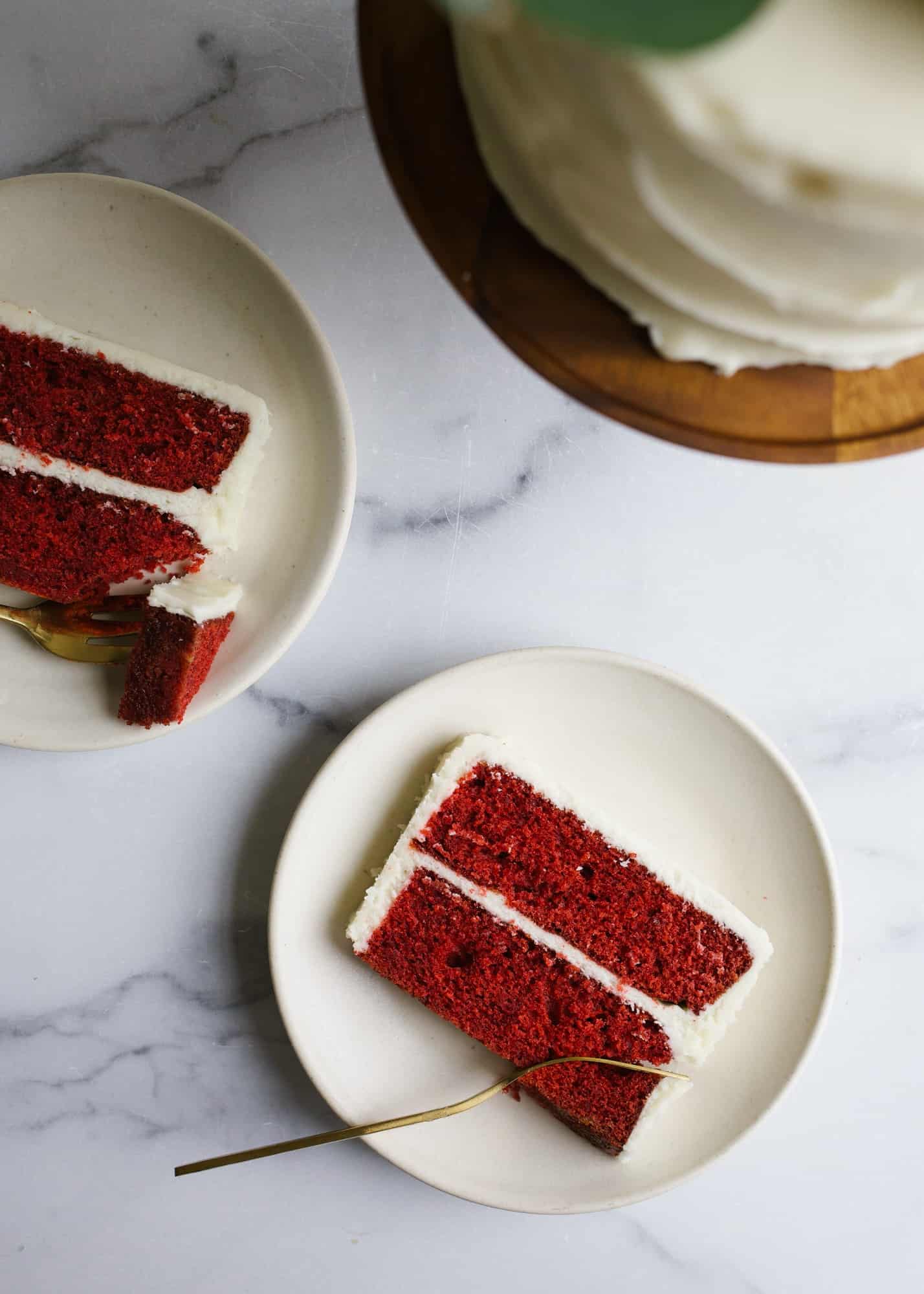 Red Velvet Cake by Wood and Spoon blog. This is a cocoa flavored layer cake with a tangy cream cheese frosting. This recipe is fluffy and festive with bright red layers and is perfect for holiday baking or birthday celebrations. Learn more about how to make this dessert on thewoodandspoon.com by Kate Wood