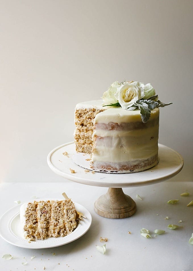 Hummingbird Layer Cake by Wood and Spoon Blog. This is a recipe for a traditional southern pecan, coconut, banana, and pineapple filled cake. The recipe comes from Katie Jacobs' new book So much to celebrate. A cream cheese frosting makes this stacked naked cake sweet and moist. Perfect for summer parties and celebrations. Find the recipe at thewoodandspoon.com