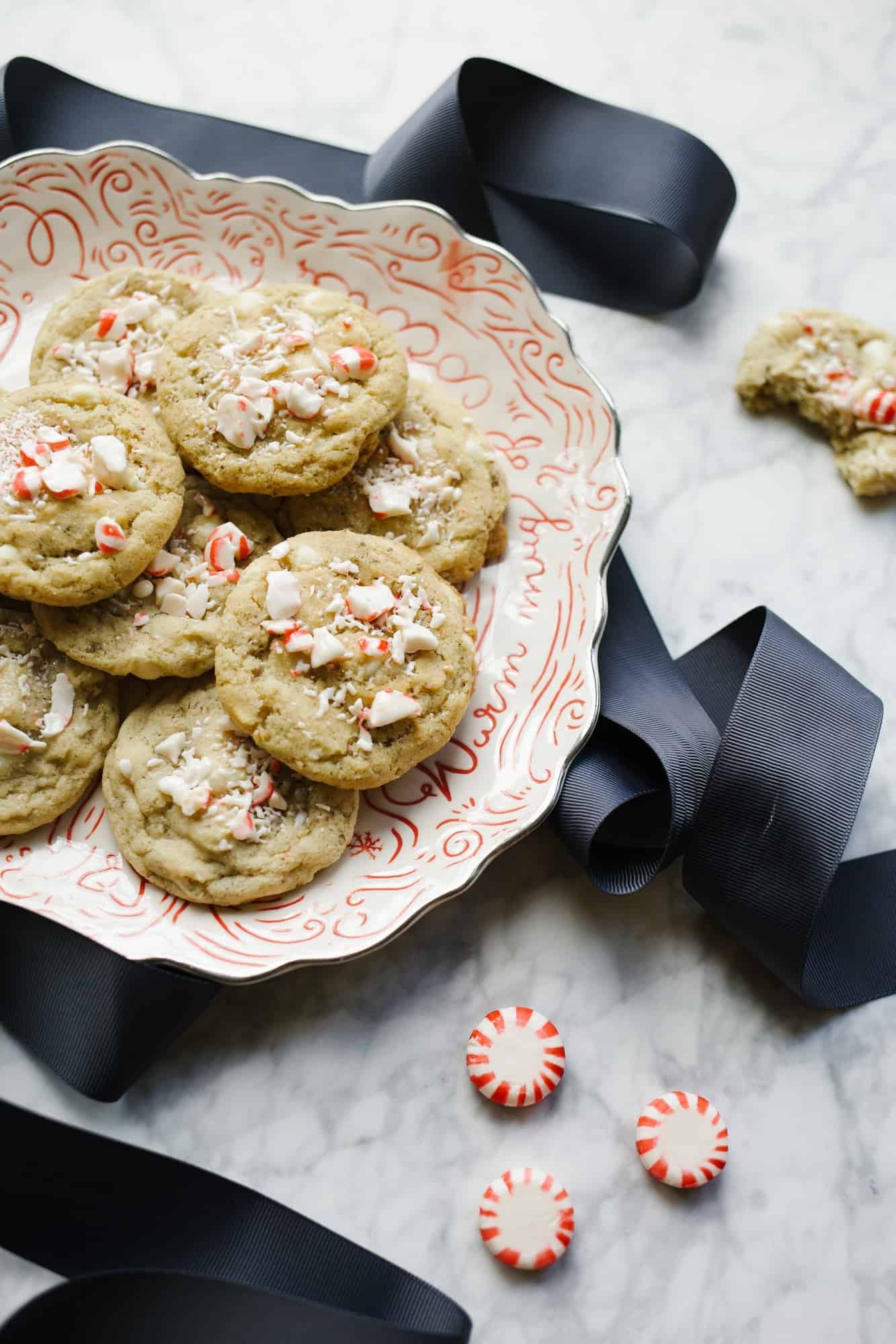 White Chocolate Peppermint Cookies by Wood and Spoon blog. These are vegan cookies with chunks of candy cane and bits of chopped white chocolate chips throughout. The cookie is made with a flaxseed egg and stays chewy throughout. Perfect for holiday and Christmas baking plates and parties and fun to make with kids! Learn more about the recipe on thewoodandspoon.com