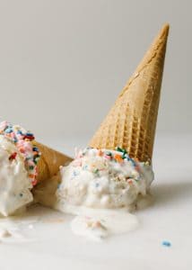 No-Churn Sugar Cookie Ice Cream Recipe. This is a simple frozen treat made with whipped cream and sweetened condensed milk. Clear vanilla flavors this birthday cake ice cream and there are chunks of eggless sprinkle sugar cookie dough. This Ice cream tastes like confetti cookie dough! So yummy, fun for kids and parties, and simple to make- no ice cream machine required! Find the recipe and how to on thewoodandspoon.com by Kate wood.