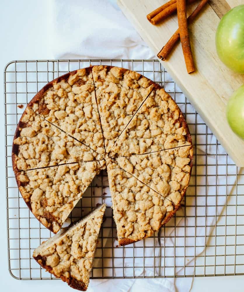 Apple Crumb Cake Recipe by The Wood and Spoon Blog by Kate Wood. This is a fun and simple way to use apples or pears or other fall produce. A simple fluffy cake recipe sweetened with applesauce and chunks of peeled apples. The topping is a crumble streusel that adds a bit of crunch to every bite. This cake is a great breakfast coffee cake or dessert to share with friends. Find the recipe at thewoodandspoon.com