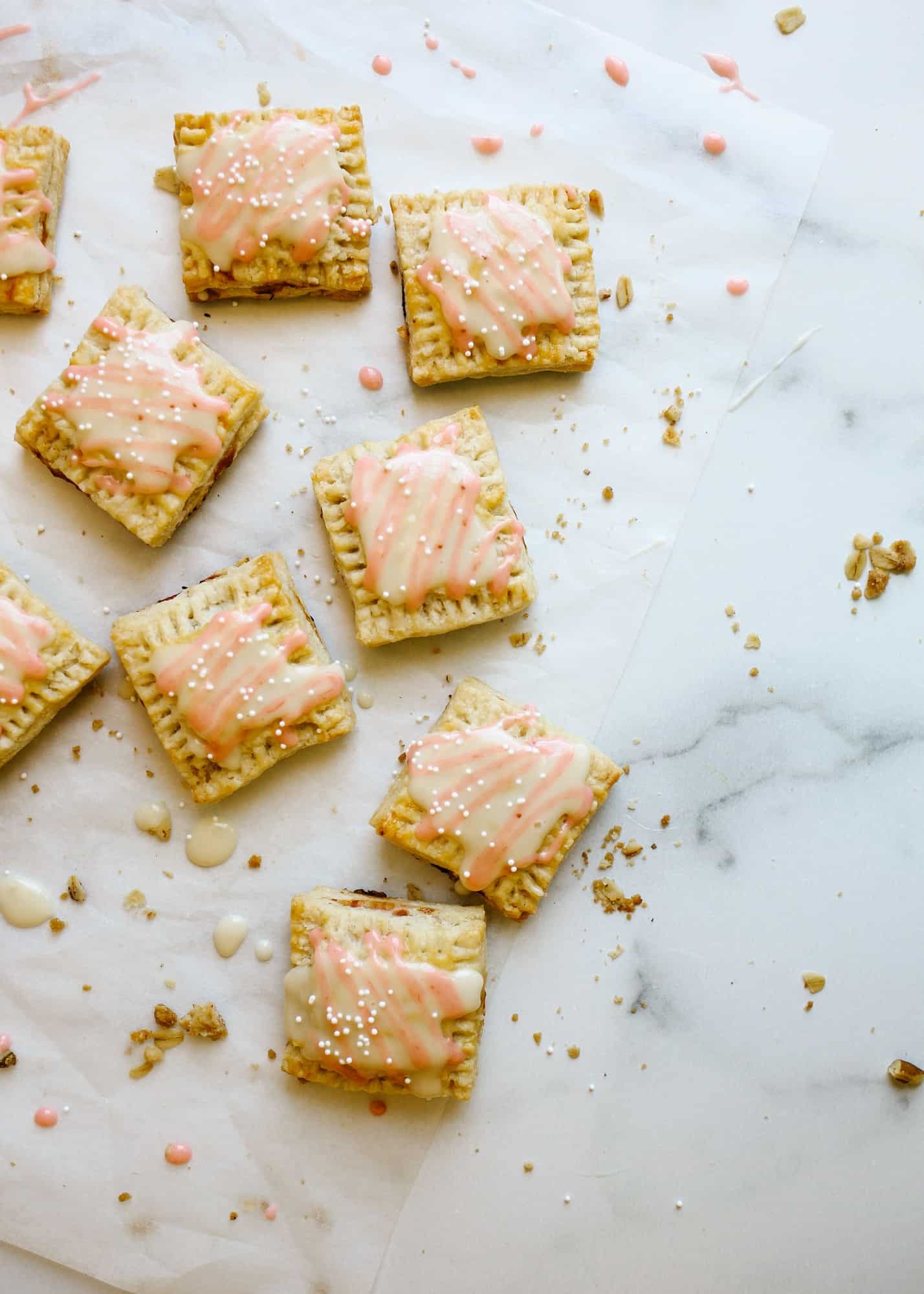 Rhubarb Pop-Tarts by Wood and Spoon blog. This recipe is for mini square hand pie breakfast pastries filled with a quite homemade rhubarb compote jam and a honey glaze icing. The hand pies can be made in advance and batches. These make fun morning treats or desserts. Learn how to DIY make from scratch pop-tarts here with simple pie dough and jelly on thewoodandspoon.com