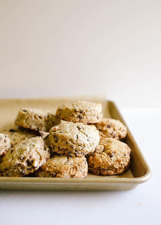 Chocolate Coffee Almond Scones Recipe by The Wood and Spoon Blog by Kate Wood. These are crisp and fluffy scones made with real butter and filled with espresso power, mini chocolate chips, and chopped almonds. These scones are made by cutting butter into the dry ingredients and are flavored with mocha and fresh nuts. Find the recipe and how to on www.thewoodandspoon.com