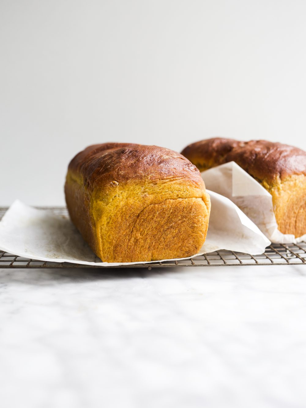 Pumpkin Swirl Bread by Wood and Spoon blog. This is a fluffy pumpkin yeast bread swirled with brown sugar and cinnamon and pumpkin pie spice. The bread is fragrant and works wonderfully for morning toast. Learn how to make a fall sandwich or yeast bread and how simple it is to add sugar to bread dough on thewoodandspoon.com