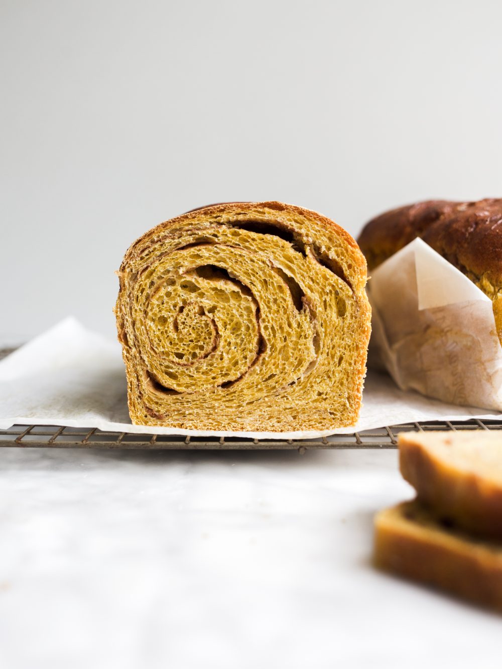 Pumpkin Swirl Bread by Wood and Spoon blog. This is a fluffy pumpkin yeast bread swirled with brown sugar and cinnamon and pumpkin pie spice. The bread is fragrant and works wonderfully for morning toast. Learn how to make a fall sandwich or yeast bread and how simple it is to add sugar to bread dough on thewoodandspoon.com