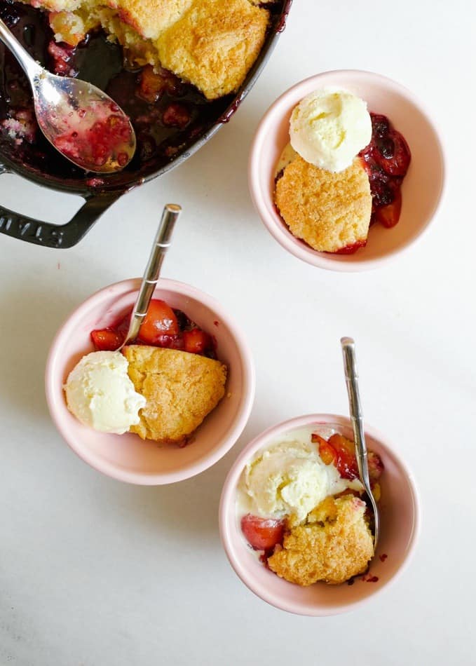 Stone Fruit Skillet Cobbler recipe by Wood and Spoon. This is a simple summer fruit dessert fit for any of your favorites- peaches, plum, berries, nectarines, cherries, etc! The topping is a biscuit / scone like topping scooped on top with cornmeal and butter. It's a simple make ahead dish that will let your summer produce shine. Find the recipe and how to on thewoodandspoon.com by Kate wood.