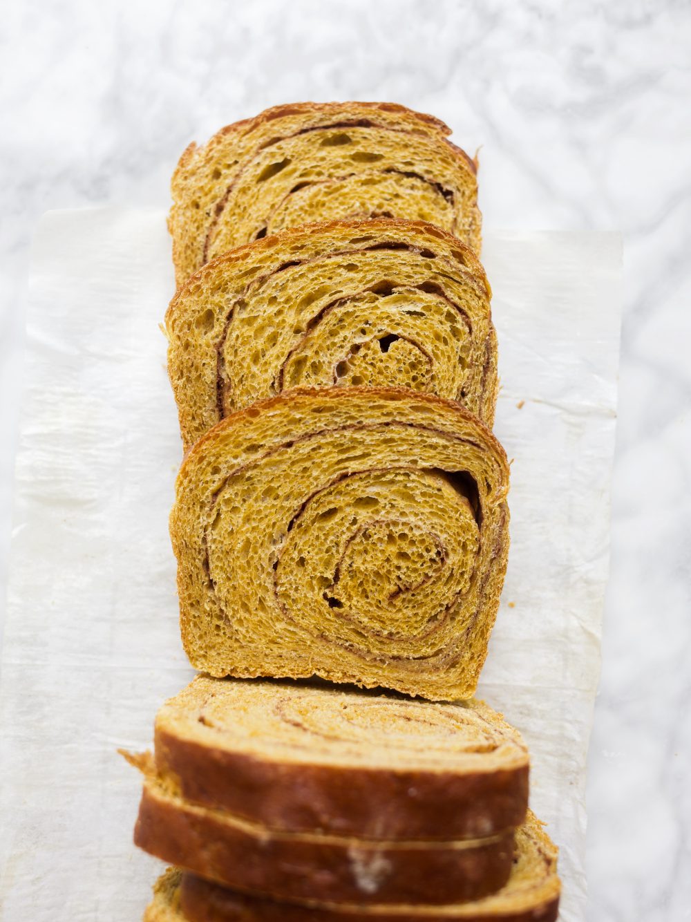 Pumpkin Swirl Bread by Wood and Spoon blog. This is a fluffy pumpkin yeast bread swirled with brown sugar and cinnamon and pumpkin pie spice. The bread is fragrant and works wonderfully for morning toast. Learn how to make a fall sandwich or yeast bread and how simple it is to add sugar to bread dough on thewoodandspoon.com