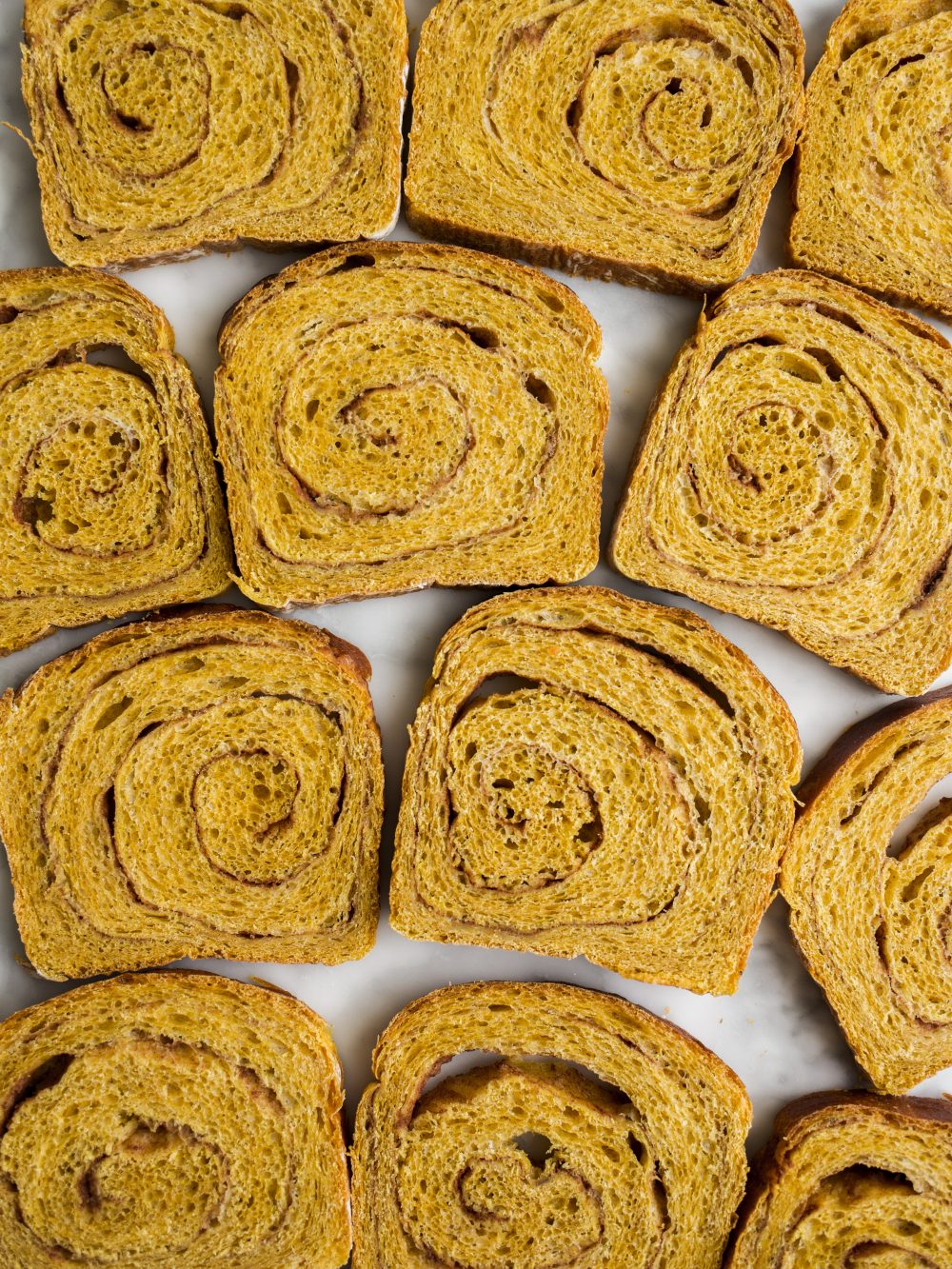 Pumpkin Swirl Bread by Wood and Spoon blog. This is a fluffy pumpkin yeast bread swirled with brown sugar and cinnamon and pumpkin pie spice. The bread is fragrant and works wonderfully for morning toast. Learn how to make a fall sandwich or yeast bread and how simple it is to add sugar to bread dough on thewoodandspoon.com