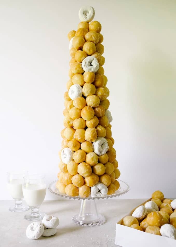 Doughnut Croquembouche Tutorial by Wood and Spoon Blog. Learn how to make the classic French celebration dessert for your upcoming parties and wedding! Just in time for Bastille day, this DIY will show you how to shortcut your way to a donut tower using store-bought treats, a styrofoam cone, and lots fo toothpicks. This is a fancy impressive dessert for parties, brunches, and everything in between. Find out the how-to on thewoodandspoon.com by Kate Wood