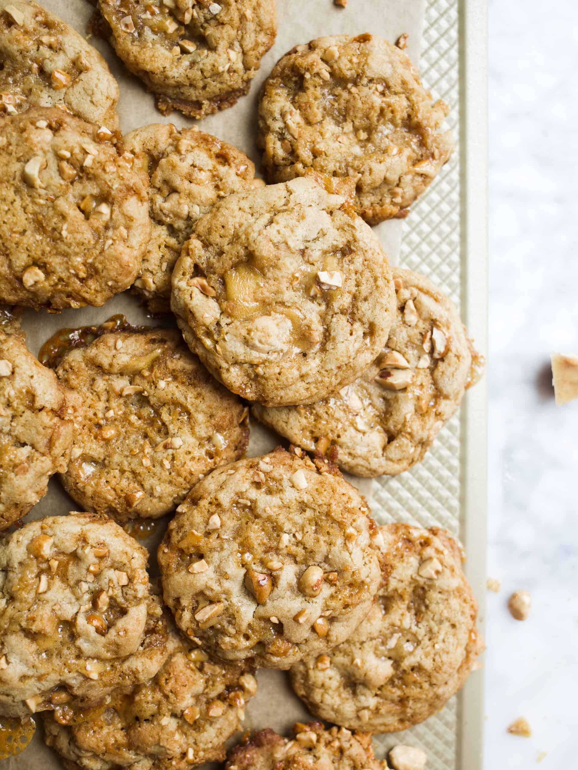 Peanut Brittle Cookies By Wood and Spoon Blog. These peanut brittle cookies feature a peanut butter dough, chopped homemade peanut brittle, and peanut butter chips. These chewy, sweet and salty cookies are a peanut butter lover’s dream! Find out how simple homemade peanut brittle is and get the recipe for these yummy fall cookies by Thewoodandspoon.com