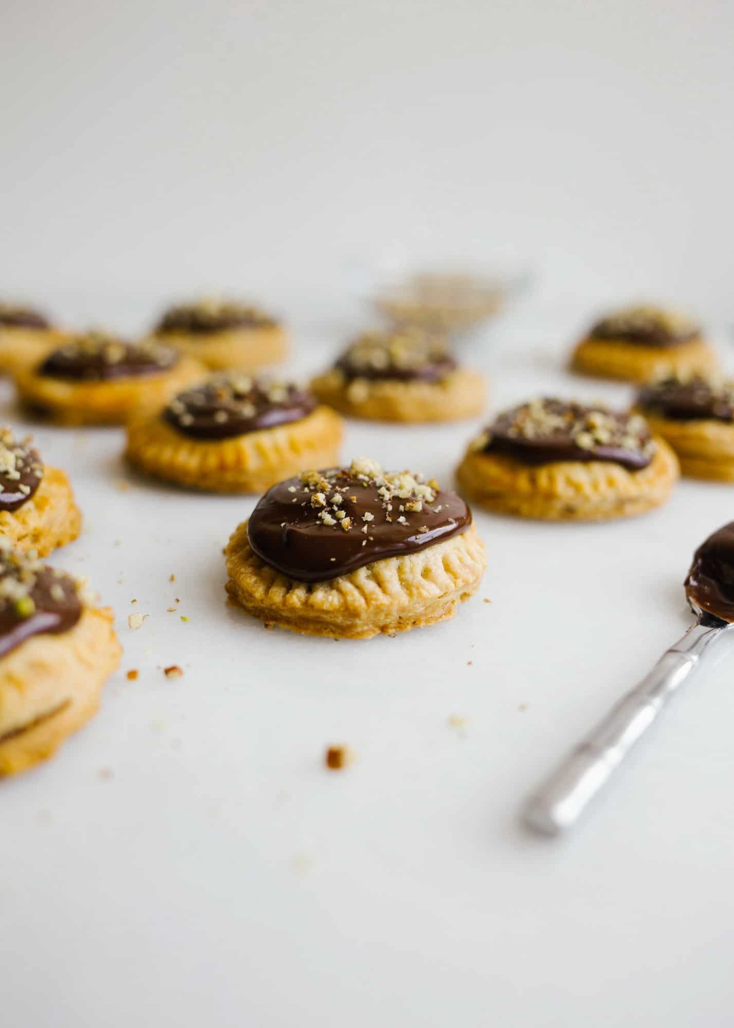 Derby Hand Pies by Wood and Spoon. These are mini pop tart pies filled with bourbon pecan pie filling and topped with a chocolate ganache and pecans. Inspired by the famous Kentucky derby party dessert, these little bite sized desserts are great for feeding a festive crowd while watching the derby. Read more about making these tiny southern pies on thewoodandspoon.com by Kate Wood.