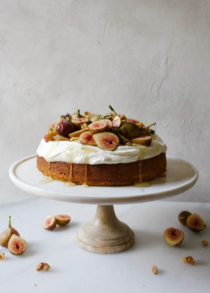 Honey Cake with Figs and Whipped Cream Cheese by Wood and Spoon. This is a single layer round honey cake topped with a cream cheese flavored stable whipped cream, fresh figs and candied Diamond walnuts. An extra drizzle of honey rounds out this simple yet elegant summer and fall recipe. Enjoy this seasonal treat recipe by Kate Wood on thewoodandspoon.com