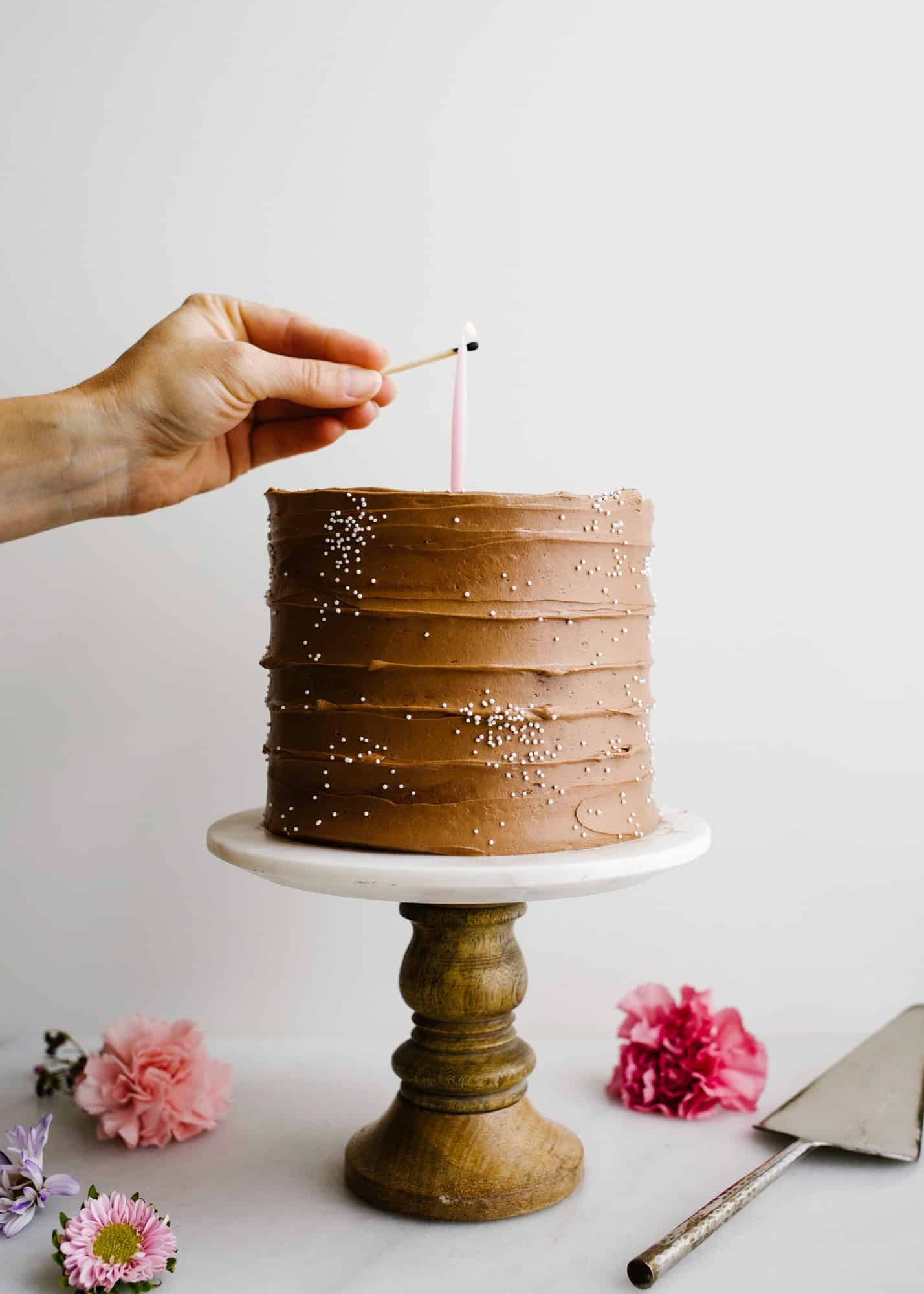 Brownie Batter Cake by Wood and Spoon. This is a fluffy cocoa powder layer cake with espresso and an eggless brownie batter filling and fluffy malt chocolate frosting. The malted chocolate adds a brownie flavor. The cake is moist and flavorful, perfect for chocolate lovers or birthday parties and celebrations. Learn more on the how to for this 3 layer cake on thewoodandspoon.com