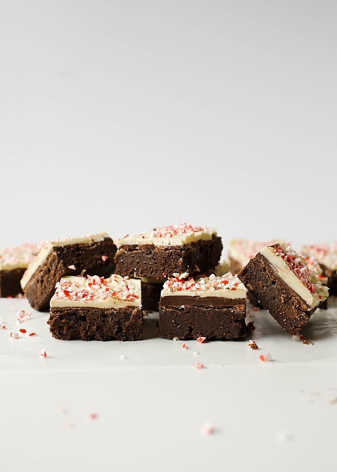 Peppermint Bark Brownies recipe by The Wood and Spoon Blog by Kate Wood. This is a fudgy chocolate brownie made with sweetened condensed milk, cocoa powder, and chocolate, topped with a peppermint bark topping of melted semisweet and white chocolate and candy cane pieces. These brownies are simple, make ahead, and feed a crowd- the perfect addition to holiday baking, cookie exchanges, and Christmas parties. Find the recipe and how to on thewoodandspoon.com