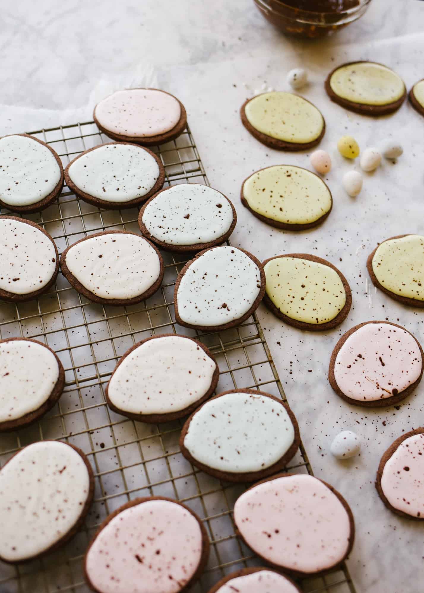 Chocolate Cutout Cookies (with Speckled Easter Egg Decorating Tutorial!) by Wood and spoon. These are cocoa powder and butter cutout cookies that are simple and don't require softened butter. You can make and freeze these in advance and the icing is simple. No royal icing- just a yummy one bowl glaze. This splattered robin egg decorating technique is a great edible easter craft for kids. Learn how to make these at home on thewoodandspoon.com