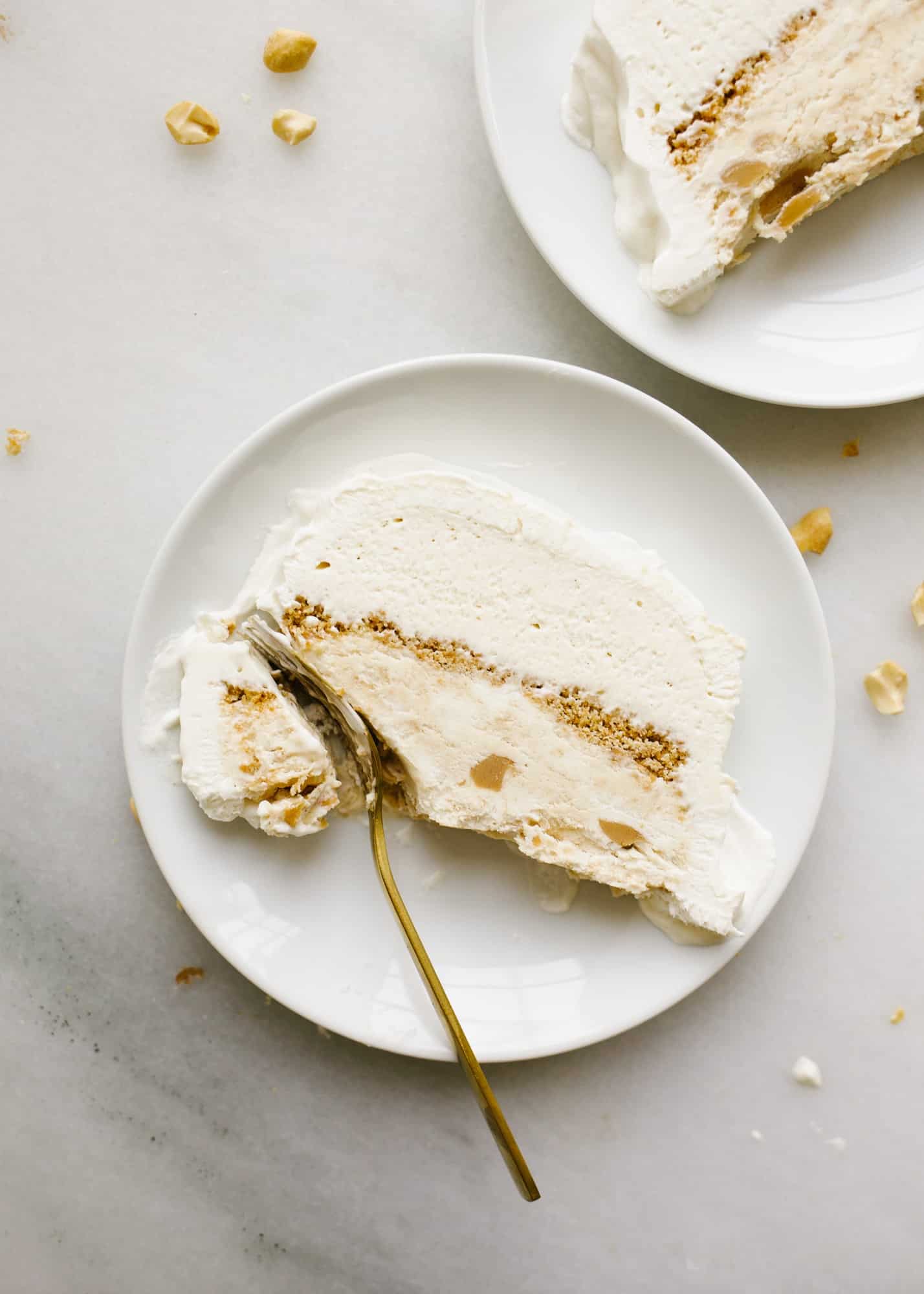 Peanut Butter Honey Graham Ice Cream Cake by Wood and Spoon blog. This is a no-churn ice cream loaf cake with a graham crumble, peanut butter ice cream, honey ice cream, and a swirl of peanut butter throughout The whole thing is topped with whipped cream and cake be made ahead to be served as a simple summer dessert. Learn how to make this homemade ice cream cake here on thewoodandspoon.com