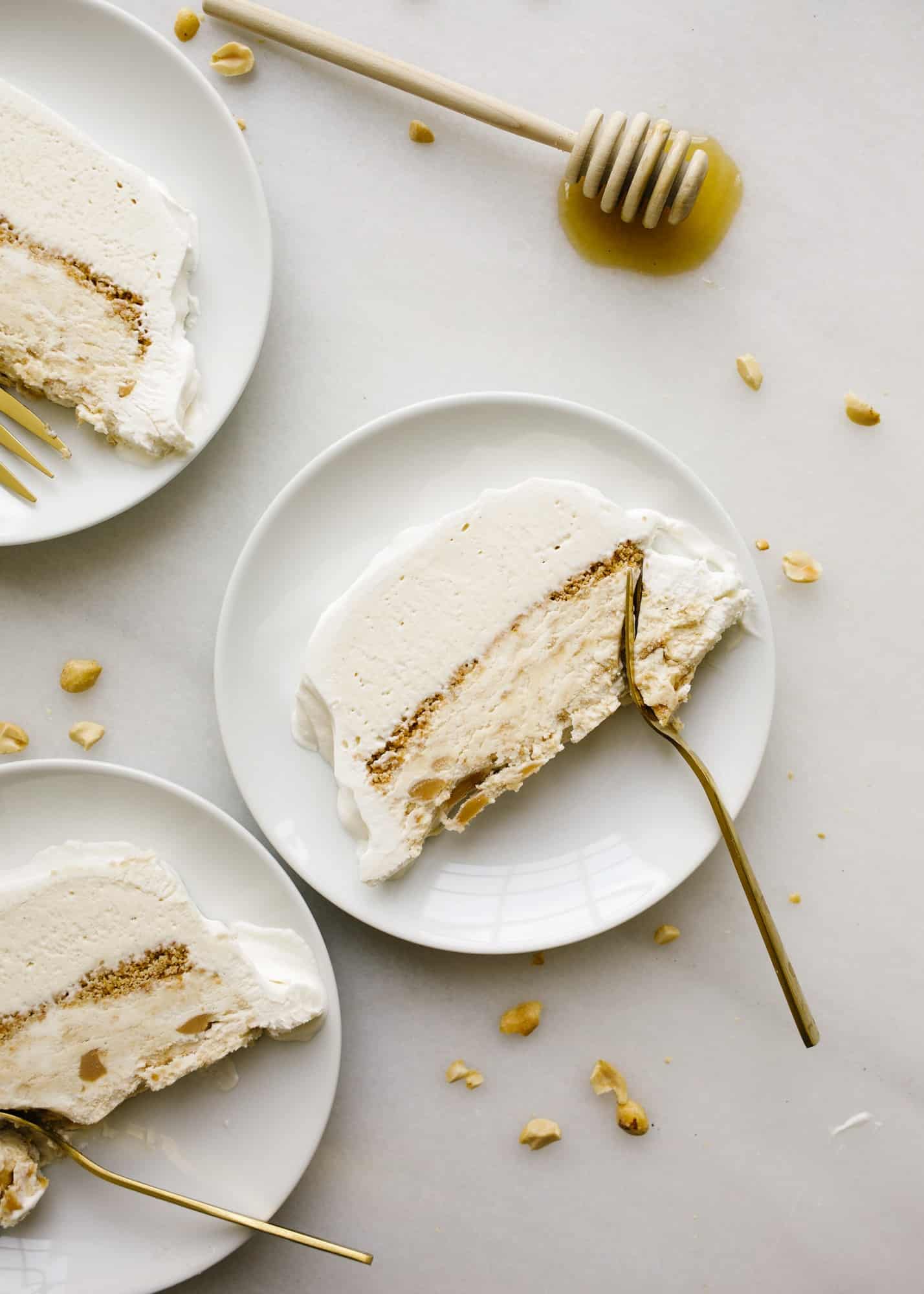 Peanut Butter Honey Graham Ice Cream Cake by Wood and Spoon blog. This is a no-churn ice cream loaf cake with a graham crumble, peanut butter ice cream, honey ice cream, and a swirl of peanut butter throughout The whole thing is topped with whipped cream and cake be made ahead to be served as a simple summer dessert. Learn how to make this homemade ice cream cake here on thewoodandspoon.com