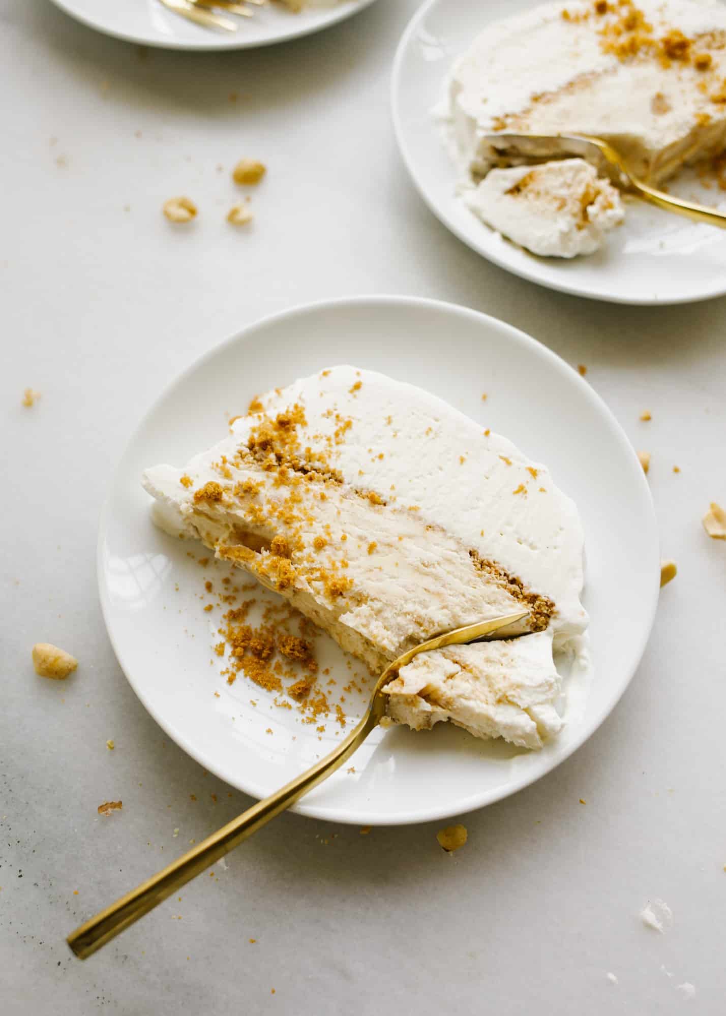 Peanut Butter Honey Graham Ice Cream Cake by Wood and Spoon blog. This is a no-churn ice cream loaf cake with a graham crumble, peanut butter ice cream, honey ice cream, and a swirl of peanut butter throughout The whole thing is topped with whipped cream and cake be made ahead to be served as a simple summer dessert. Learn how to make this homemade ice cream cake here on thewoodandspoon.com