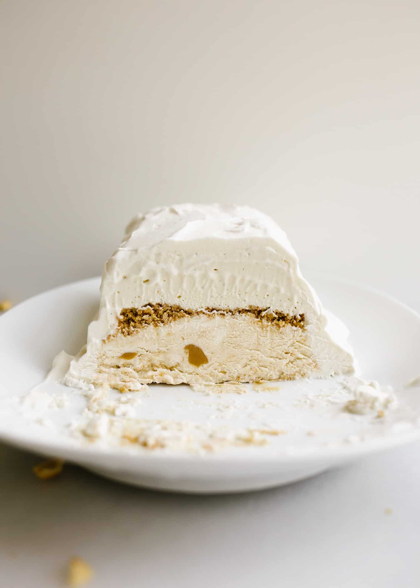 Peanut Butter Honey Graham Ice Cream Cake by Wood and Spoon blog. This is a no-churn ice cream loaf cake with a graham crumble, peanut butter ice cream, honey ice cream, and a swirl of peanut butter throughout The whole thing is topped with whipped cream and cake be made ahead to be served as a simple summer dessert. Learn how to make this homemade ice cream cake here on thewoodandspoon.com