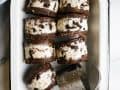 Brownie Ice Cream Sandwiches by Wood and Spoon blog. These are soft baked brownies stuffed with a no churn cookies and cream Oreo ice cream filling. The brownies stay chewy when frozen and this recipe makes a batch to feed a crew. Learn how to make homemade frozen treats without an ice cream maker on thewoodandspoon.com