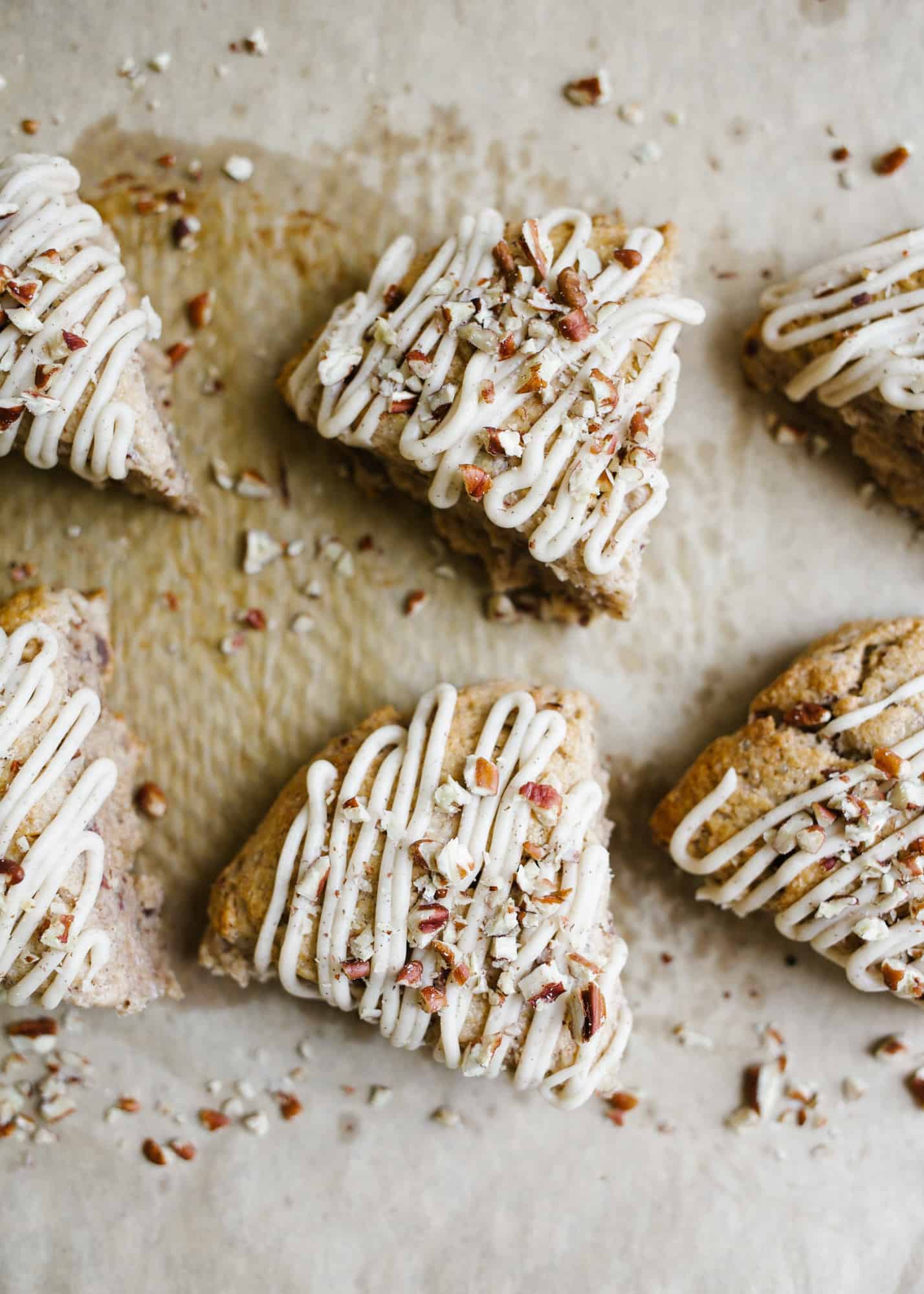 Pecan Scones with Brown Butter Glaze by Wood and Spoon blog. These are simple cream scones scented with cinnamon and iced in a simple brown butter icing. The scones are tender and small batch, the perfect serving size for a small family. Learn how to make this easy breakfast pastry recipe using nuts on thewoodandspoon.com