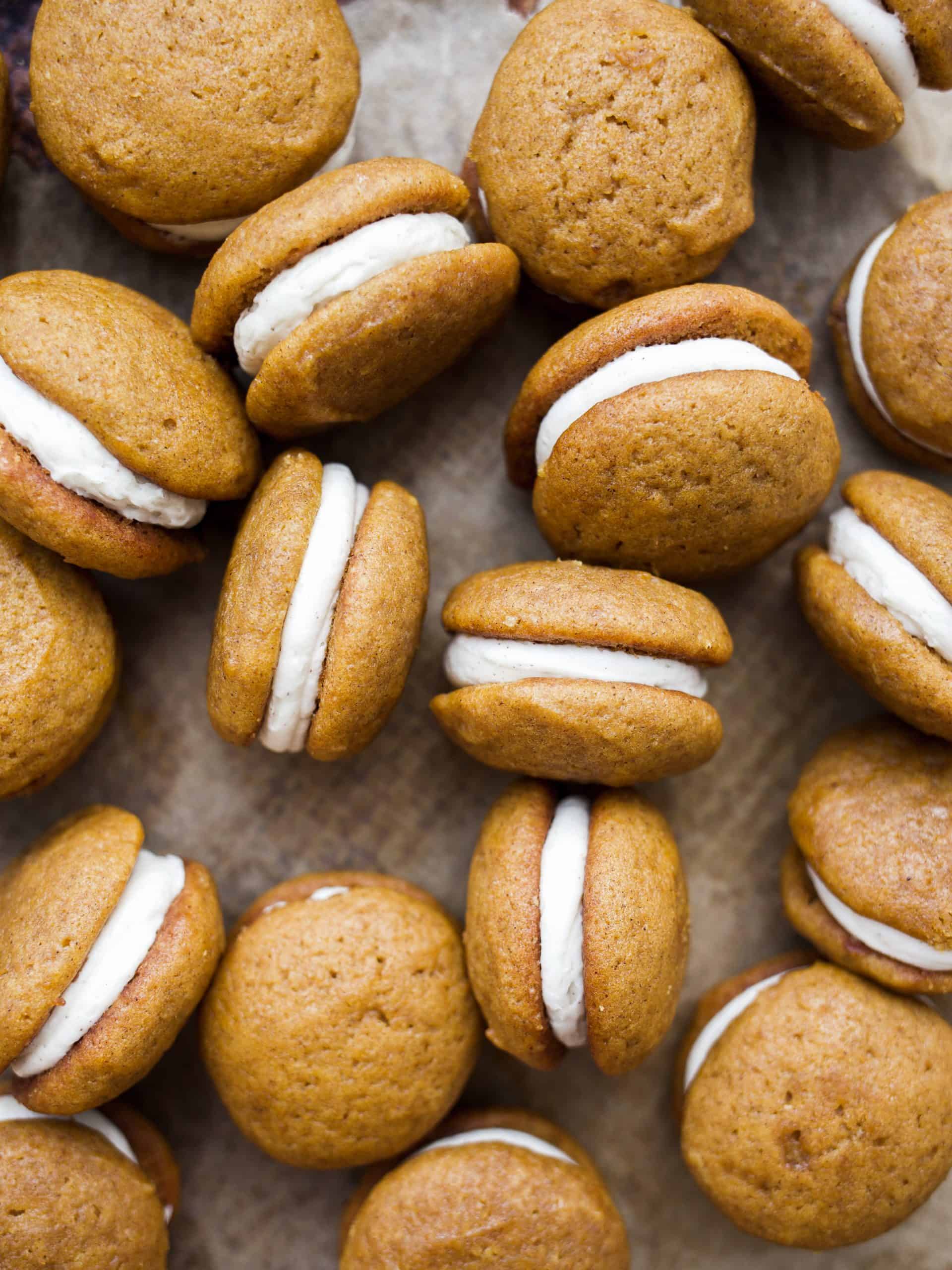 Pumpkin Whoopie Pies with Brown Butter Buttercream by Wood and Spoon blog By Kate Wood. These are soft and fluffy cake-like cookies flavored with pumpkin puree and pumpkin pie spice. These little cakes sandwich a rich brown butter buttercream that can be made in 5 minutes. Learn how to make pumpkin whoopie pies and American buttercream on thewoodandspoon.com